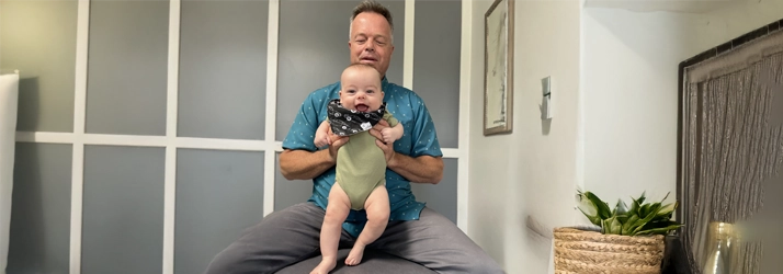 Dr. Ron M. French carring a cute baby